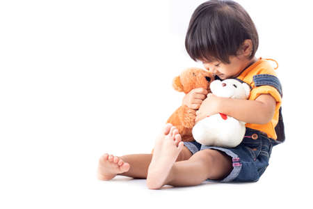 Little girl is playing dolls.