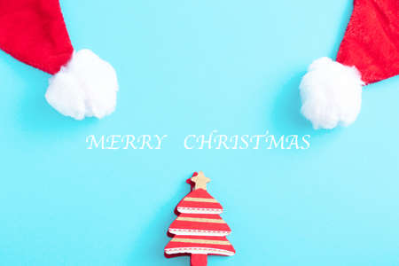Red Christmas hat and Christmas trees on a blue background.