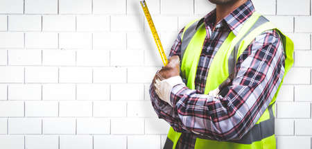 Worker is building a brick wall.