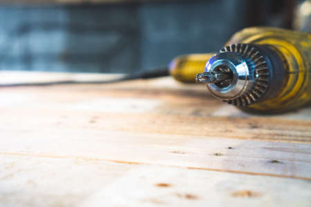 The drill used in construction is placed on the table.の写真素材