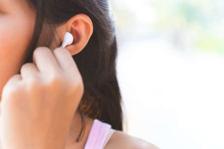 Women are listening to music from headphones during exercise.の写真素材