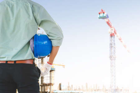The male engineer is inspecting the building structure in the construction site.