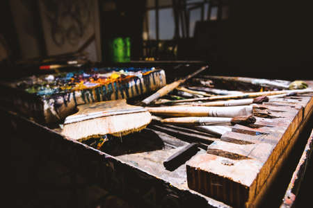 Color fragments stained on paper sheets from art and paint brushes.の写真素材