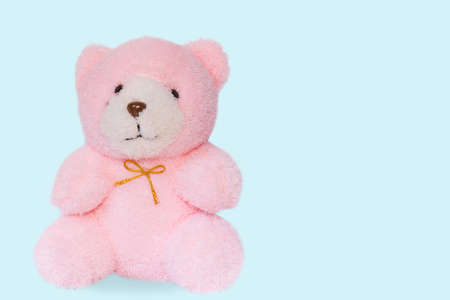 Soft pink teddy bear on the ground.の写真素材