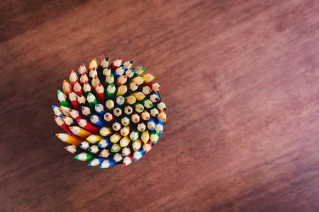 Multiple colored pencils in the box on the table.