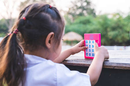 The girl is playing arranged numbers with determination.の写真素材