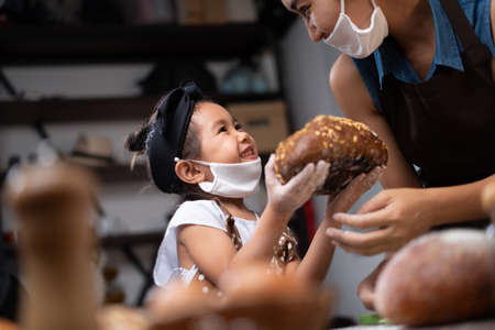 Mother and daughter bake bread together during the quarantine.