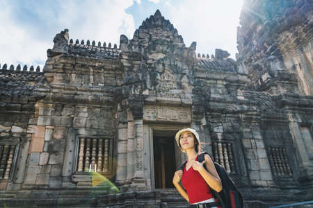 A young tourist is visiting the ancient stone castle.の写真素材