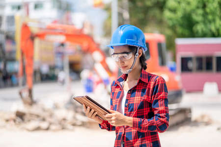 A female engineer is inspecting work at the construction site.の写真素材