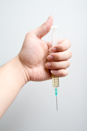 syringes in handの写真素材