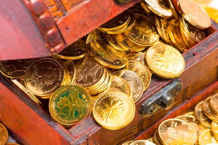 gold coins in wooden box
