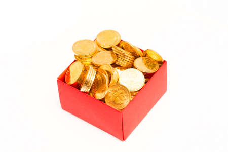 gold coins in red box on white backgroundの写真素材