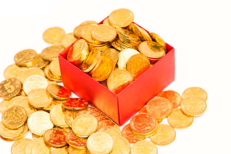gold coins in red box on white backgroundの写真素材