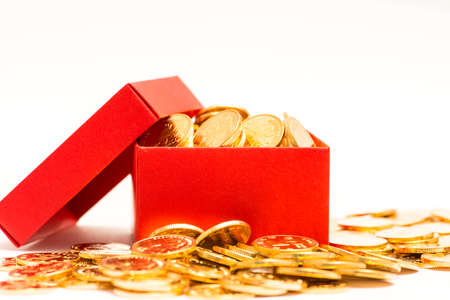 gold coins in red box on white backgroundの写真素材