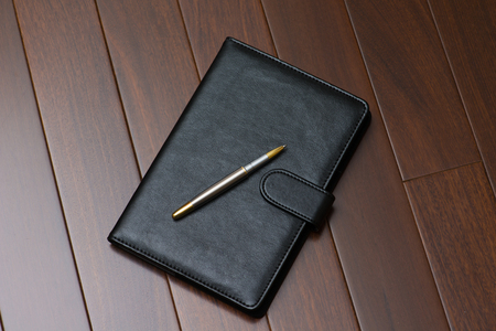 Notepad with ball penの写真素材