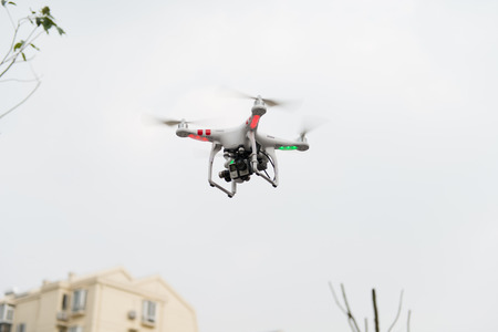SHANGHAI,CHINA-April 30,2015:Flying drone quadcopter Dji Phantom 2 with digital camera GoPro HERO4.