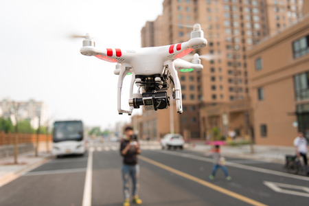 SHANGHAI,CHINA-April 30,2015:Flying drone quadcopter Dji Phantom 2 with digital camera GoPro HERO4.
