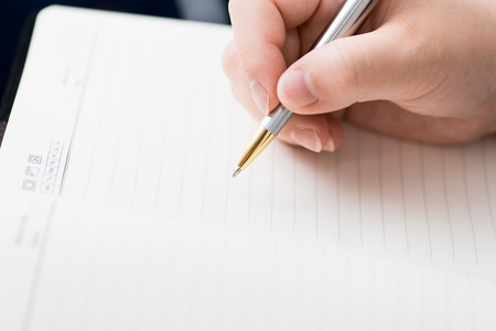 Woman writing on paperの写真素材