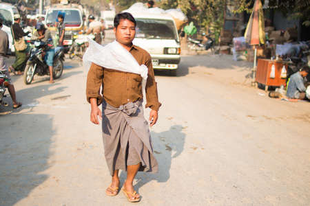 Mandalay, Myanmar  - 22  February 2015 . The unidentified man walking in the street with the unique suit.のeditorial素材