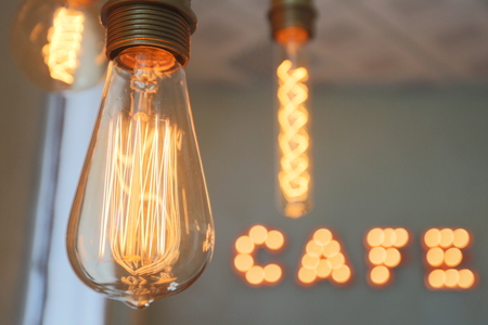 Yellow vintage electric lamp in a cafeの写真素材