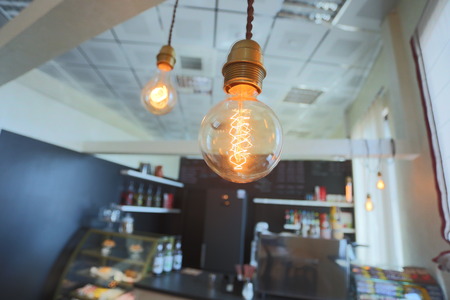 Yellow vintage electric lamp in a cafeの写真素材