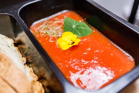 Healthy food and diet concept, restaurant dish delivery. Take away of fitness meal. Weight loss nutrition in foil boxes. Steamed veal with cous and vegetables at woodの写真素材