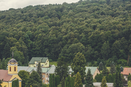 View of mountain forest landscape under sunlight in the middle of the summer with heavy blue sky as a background. Green wood mountain forest in clouds scenery.の写真素材