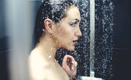 Beautiful sexy  young woman washing body in a shower