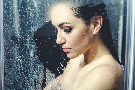 Beautiful sexy  young woman washing body in a showerの写真素材