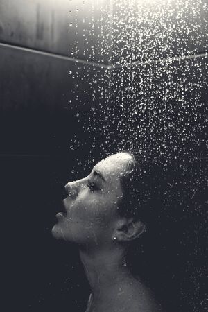 Beautiful sexy  young woman washing body in a showerの写真素材