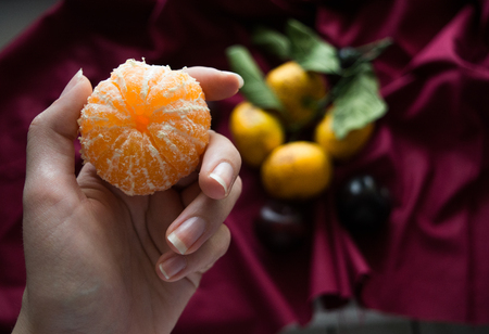 tangerine in hand background new year ,meri christmas winterの写真素材