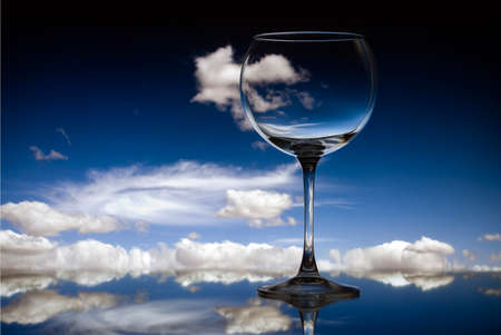 Empty glass showing the sky and reflecting on the ground