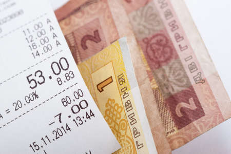 cheque in grocery store and change on background