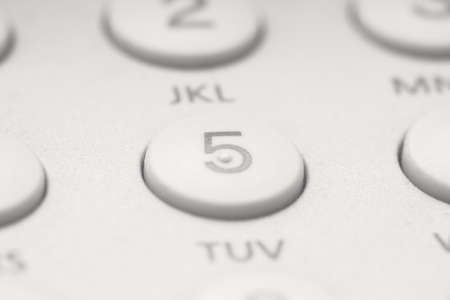 button five on white telephone keyboard, can be used as backgroundの写真素材