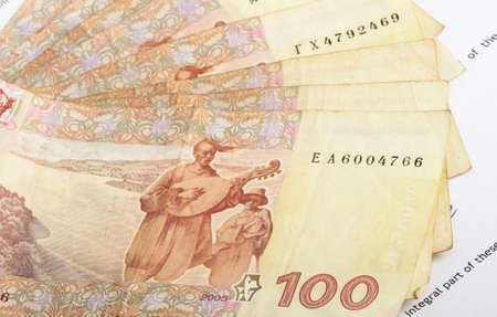 many ukrainian banknotes of hundreds laid out on documentの写真素材