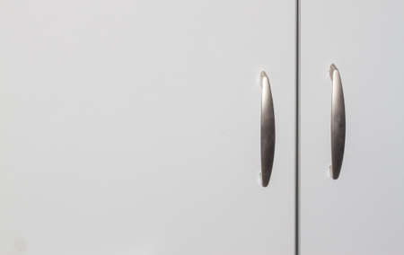 grey cabinet doors with two handles can be used as backgroundの写真素材