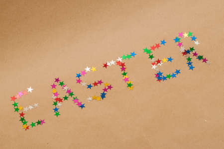 word easter made of colorful toy stars on kraft backgroundの写真素材