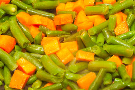 cut green asparagus beans and diced orange carrotの写真素材