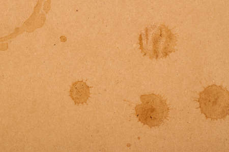coffee cup and drop spots on kraft backgroundの写真素材