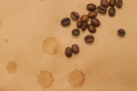 coffee beans and cup spot on brown kraft backgroundの写真素材