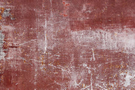 red scratched metal surface with peeling paintの写真素材