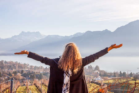 Women on background fo vineyards and Geneva lakeの写真素材