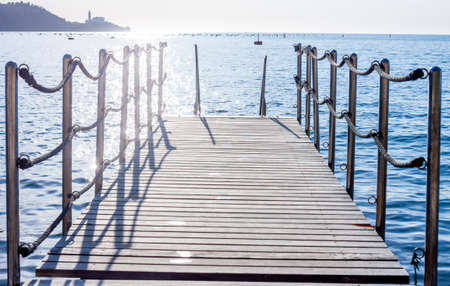 small pier on background of sunset over the Adriatic sea