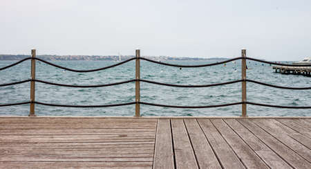 Empty wooden seafront with fence can be used as backgroundの写真素材