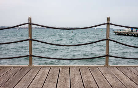 Empty wooden seafront with fence can be used as backgroundの写真素材