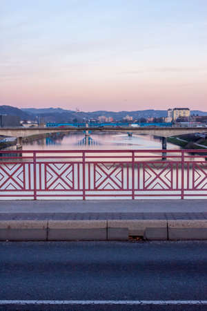 Sunset over the river and bridges in Slovenian city Mariborの写真素材