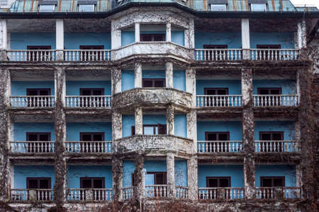 blue abandoned hotel exterior overgrown with ivyの写真素材