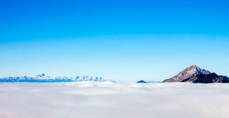 View on mountains and blue sky above cloudsの写真素材