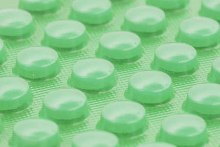 green pills in blister pack can be used as backgroundの写真素材