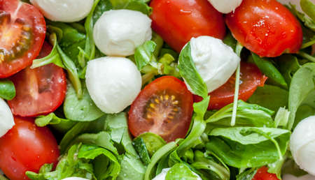 homemade caprese salad with cherry tomatoes and mozzarella cheese